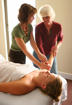 Instructor and student collaborating on a massage