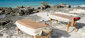 Massage tables displayed on the beach