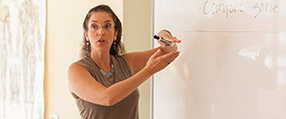 An SSMT instructor teaching class before a whiteboard